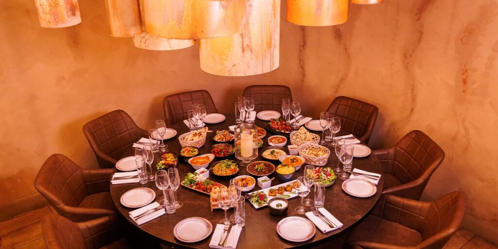 A spacious dining room with a large table and chairs, perfect for enjoying an Indian restaurant near me.