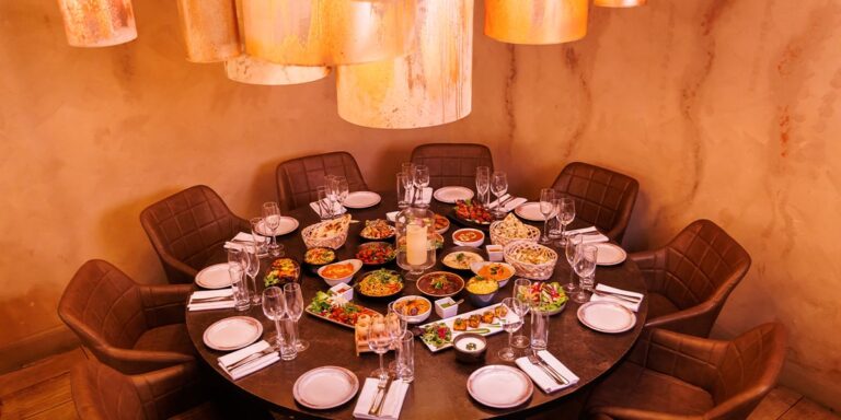 A spacious dining room with a large table and chairs, perfect for enjoying an Indian restaurant near me.